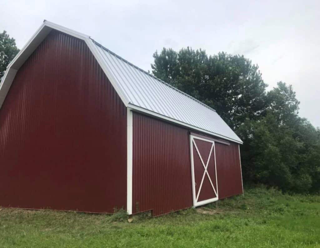 A Red Metal Barn with White Trim